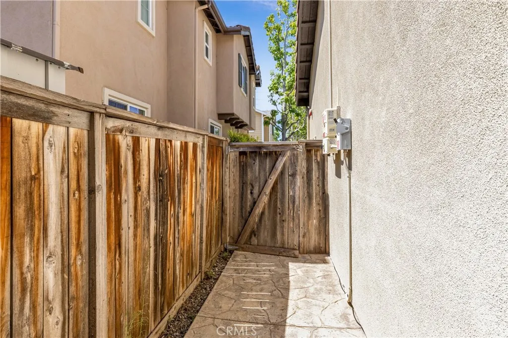 Pathway behind home wraps around past garage to side fence Pathway behind home wraps around past garage to side fence