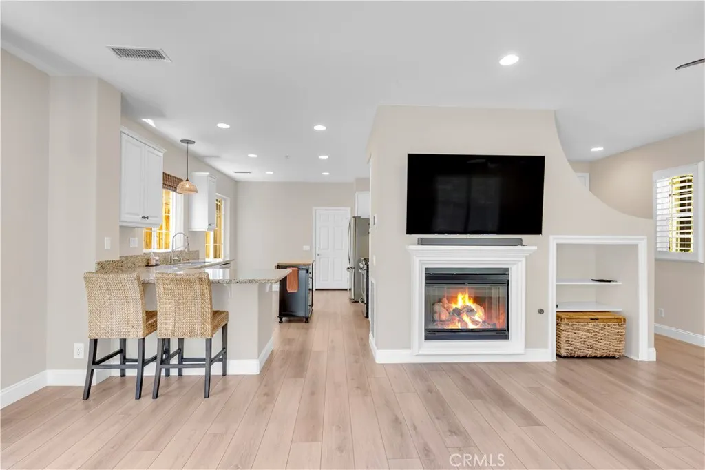 Modern light fixtures, oak-look laminate flooring, multiple dining spaces Modern light fixtures, oak-look laminate flooring, multiple dining spaces