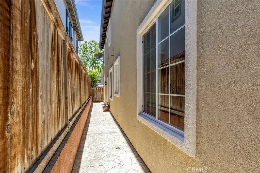 Pathway behind home wraps around past garage to side fence Pathway behind home wraps around past garage to side fence