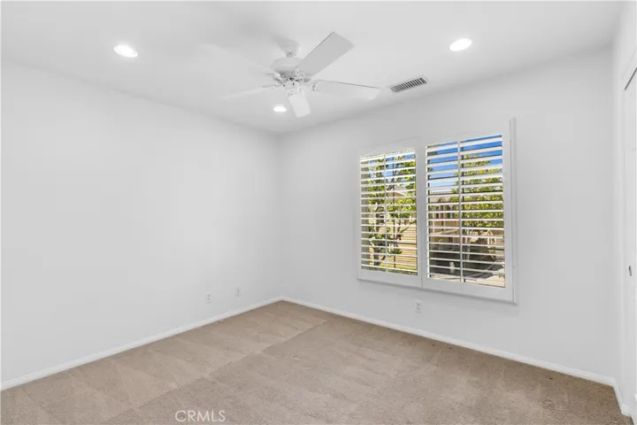 Upstairs bedroom with recessed lighting + ceiling fan