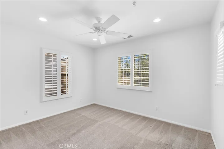 Upstairs bedroom with recessed lighting + ceiling fan