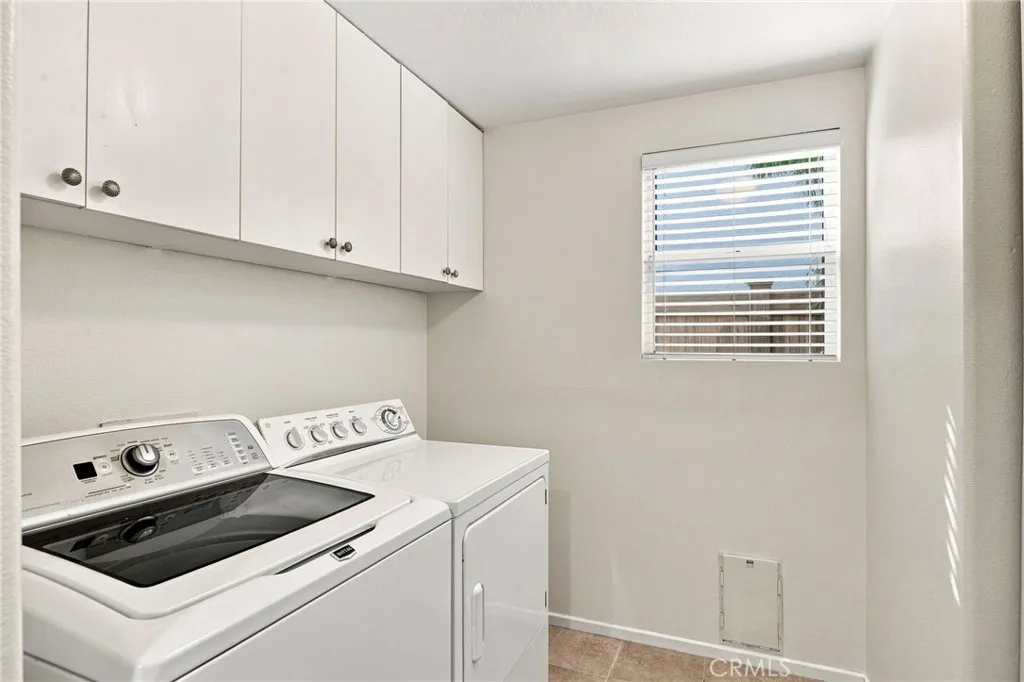 Laundry room with doggy door & lots of storage. Laundry room with doggy door & lots of storage.