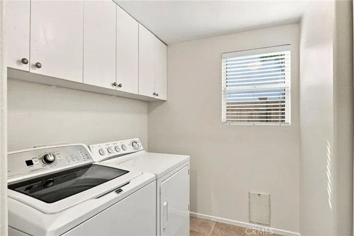 Laundry room with doggy door & lots of storage.