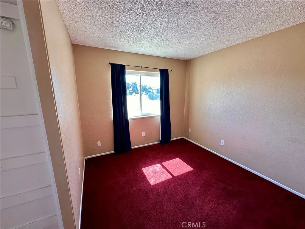 Natural light fills this versatile bedroom, featuring a generous footprint, neutral walls, and carpeting. Natural light fills this versatile bedroom, featuring a generous footprint, neutral walls, and carpeting.