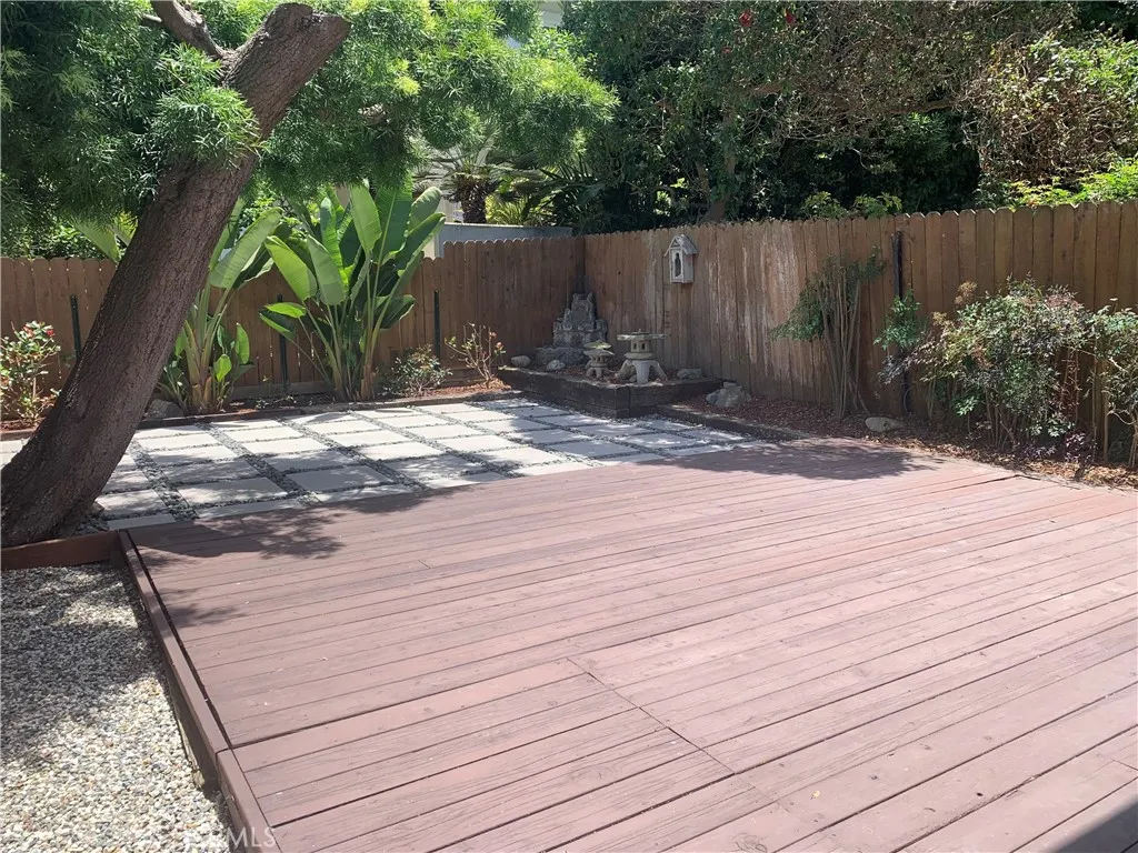 Clean backyard and deck and tree has been removed since this photo was taken