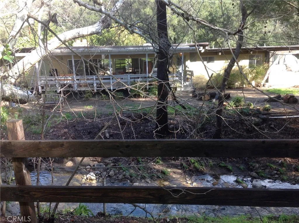 House and back yard and patio from across Cold Creek.