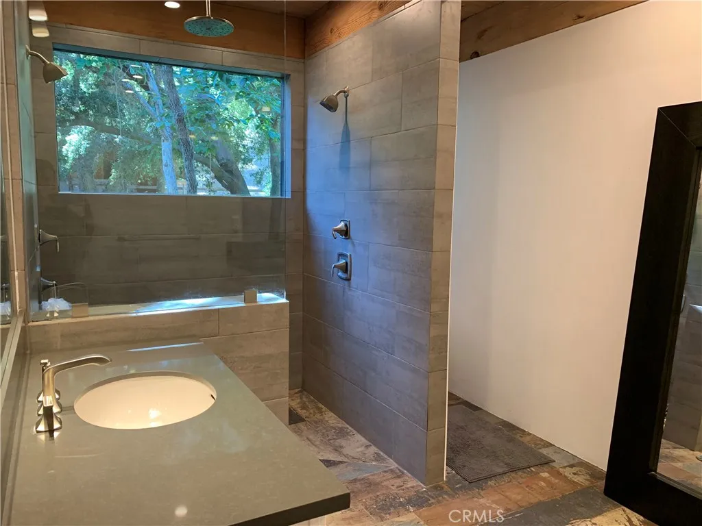 Large Master Bath with his and her marble top pullmans, 3 shower heads,and views. damsel shower entry.