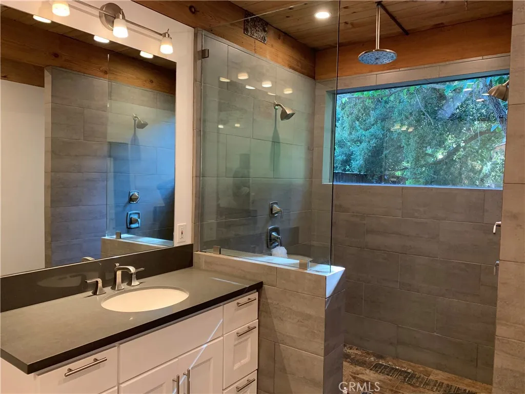 Master suite includes large shower with 2 showers, and also include a. large Rainshower head. Also 2 separate sinks, mirrors and custom lighting throughout.