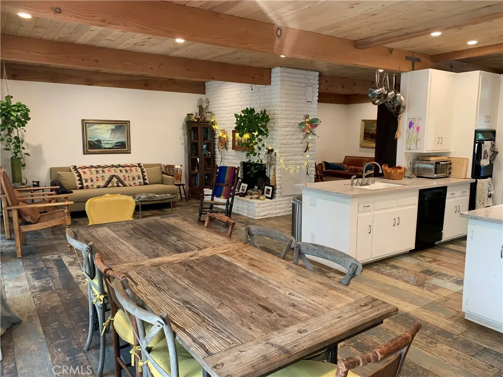 Everybody's together and connected to each other and the nature outside in this homey open living space. with the sliders open on warm summer nites, or cozy  around the fireplace on cold winter nights. Family time.