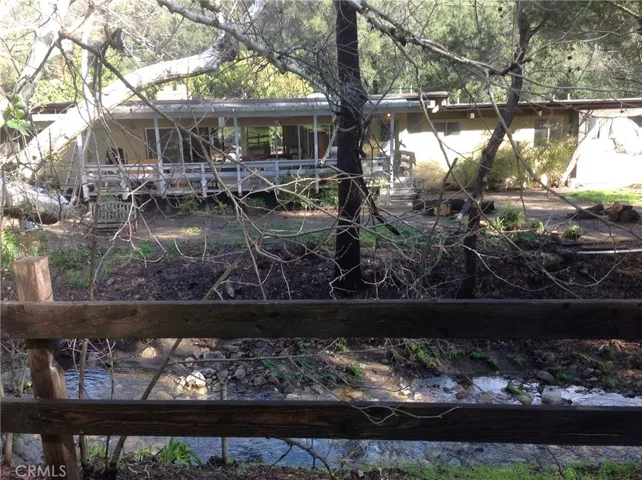 House and back yard and patio from across Cold Creek.