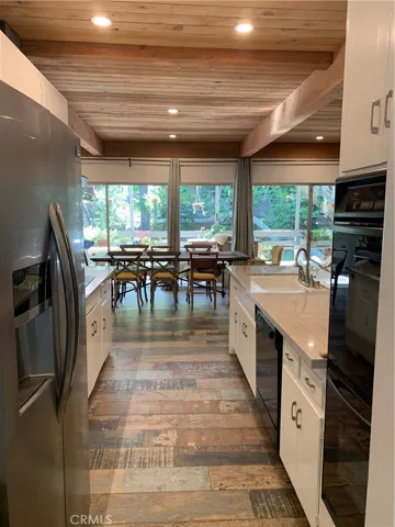Its all glass to bring the view in out back over the beautiful streamed and grassy hills.