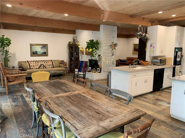 Everybody's together and connected to each other and the nature outside in this homey open living space. with the sliders open on warm summer nites, or cozy  around the fireplace on cold winter nights. Family time.