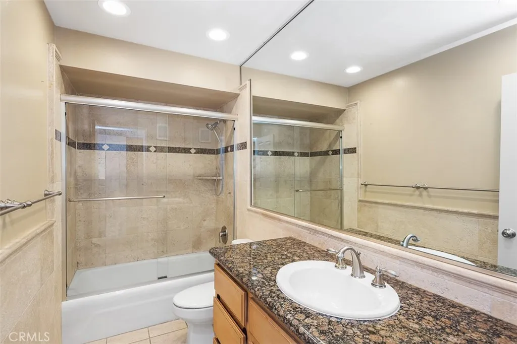 Granite counters. Shower tub with glass enclosure
