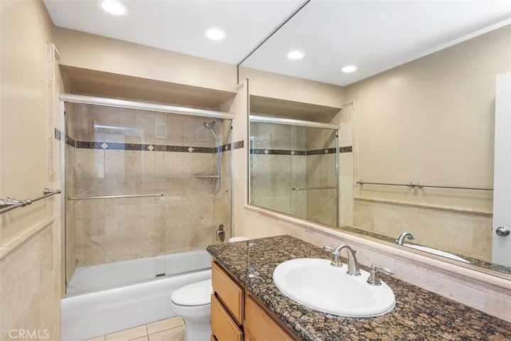 Granite counters. Shower tub with glass enclosure