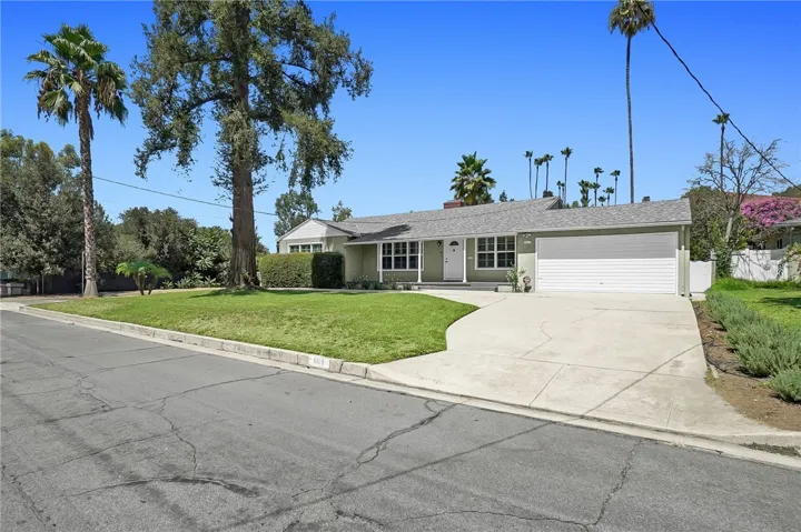 Beautiful circular driveway with attached garage greets you home.
