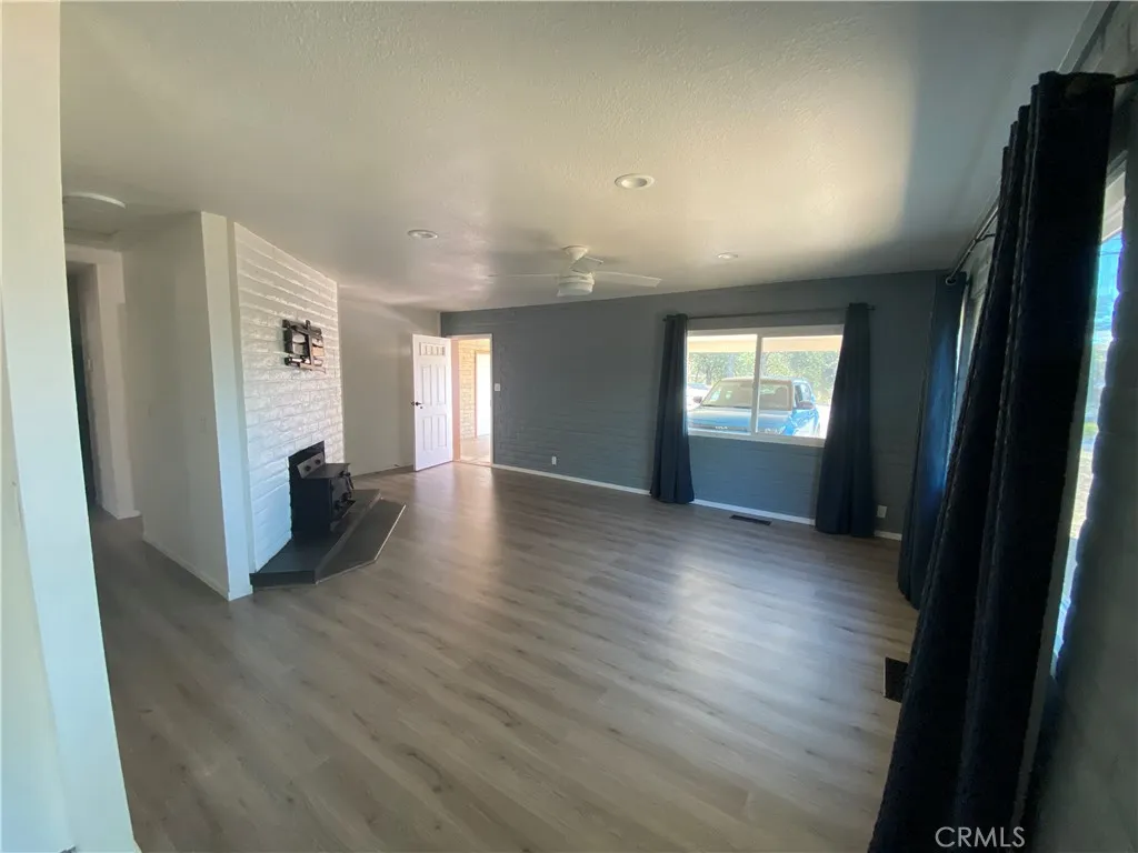 Large living area with wood stove. Large living area with wood stove.