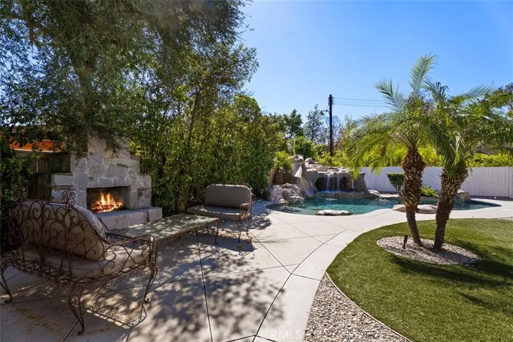Resort Style Backyard with Rockscape Pool, Spa and Fireplace