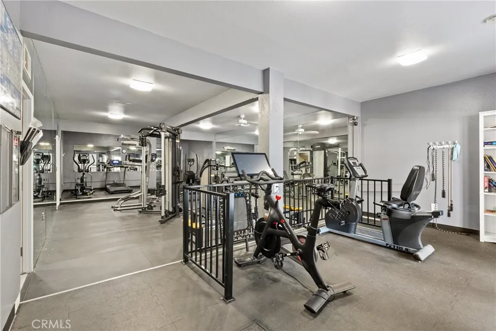 The gym is located by a pool and clubhouse.