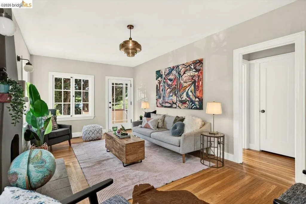 Hardwood flooring, painted interior walls, built-in fireplace, French door, and a multi-pane window Hardwood flooring, painted interior walls, built-in fireplace, French door, and a multi-pane window