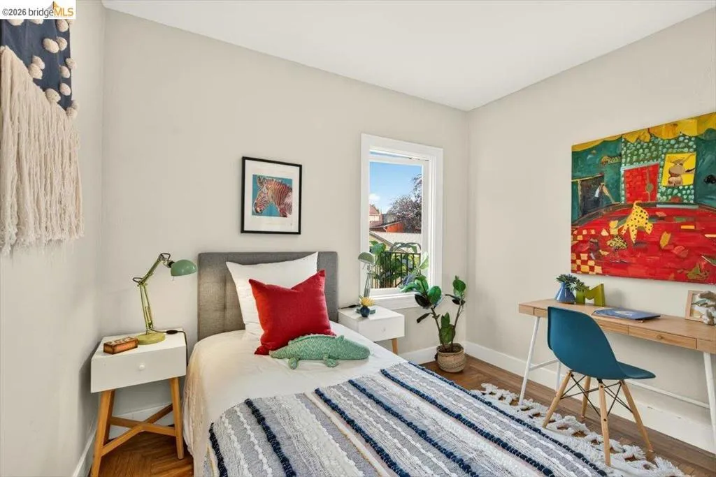 Hardwood flooring, painted walls, and a window with natural light Hardwood flooring, painted walls, and a window with natural light