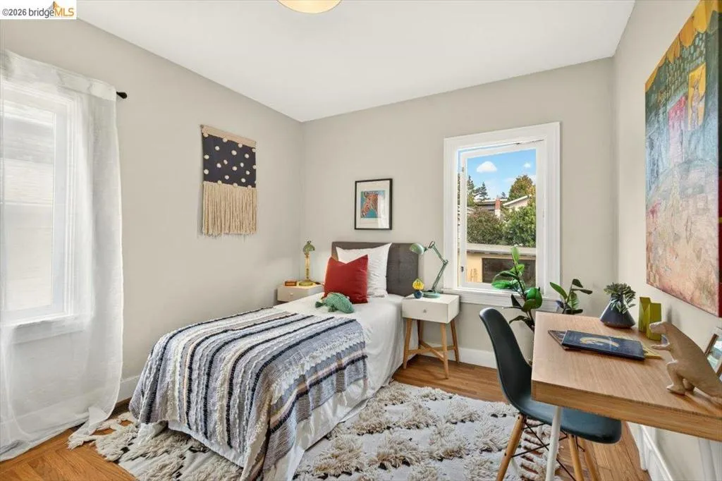 Hardwood flooring, painted walls, white trim, and natural light from multiple windows Hardwood flooring, painted walls, white trim, and natural light from multiple windows