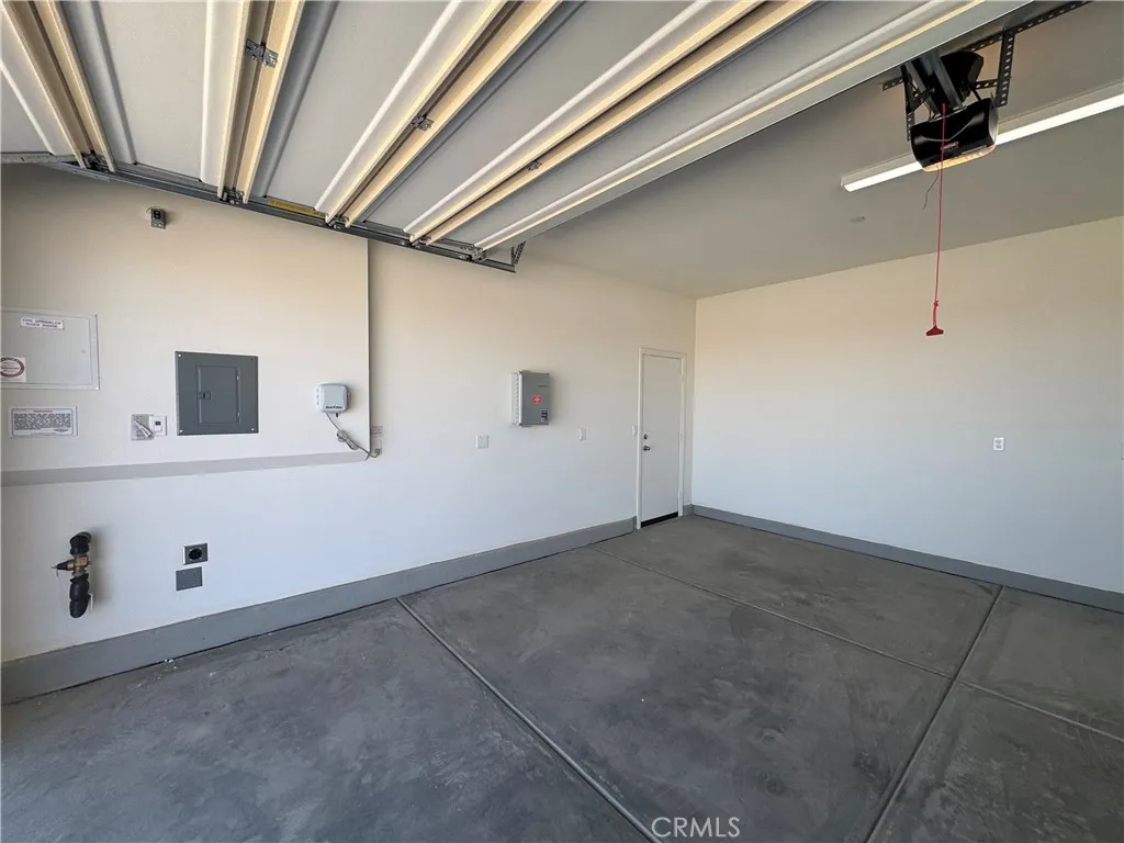 garage with smart light feature and automatic sprinkler system for backyard