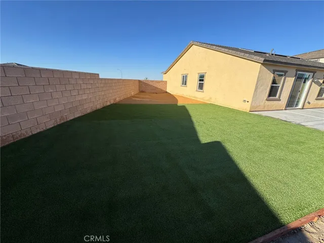 turf and concrete covering most backyard