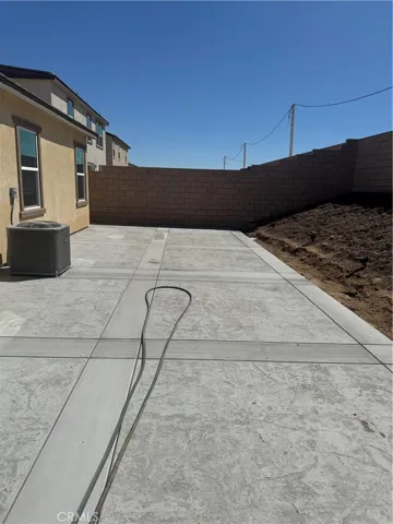 large area with concrete in the backyard