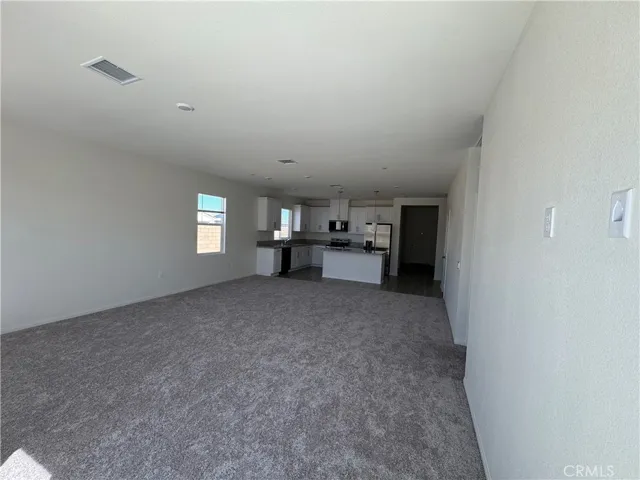 large family room with high ceilings and wired for flat screen TV