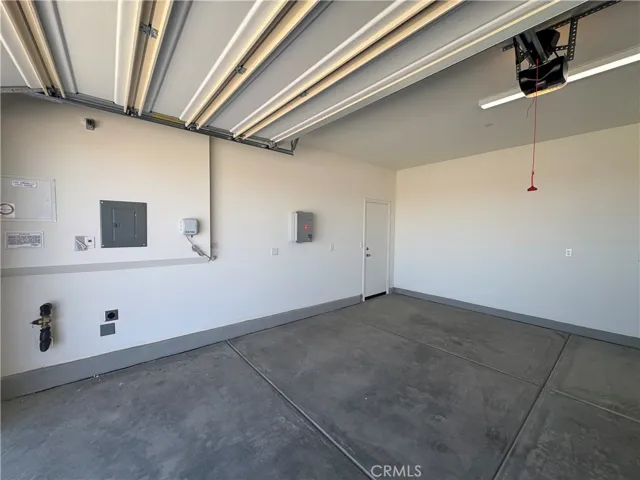 garage with smart light feature and automatic sprinkler system for backyard