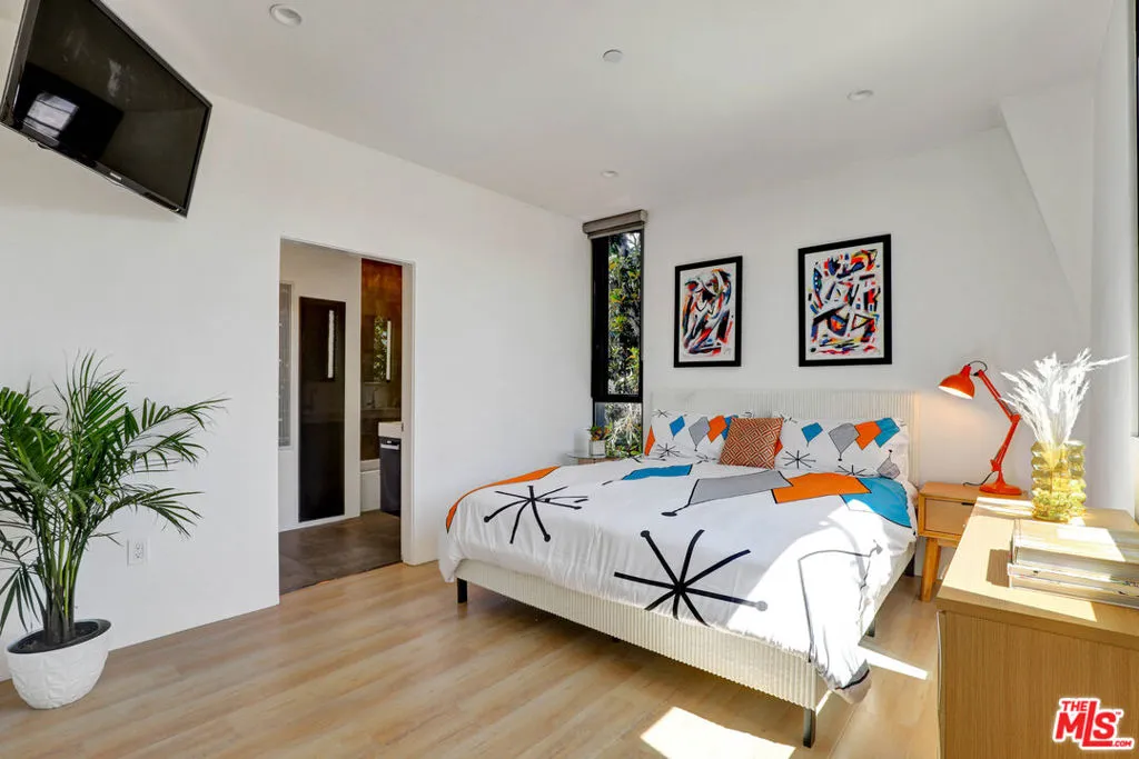 Bright primary bedroom with ta Bright primary bedroom with ta