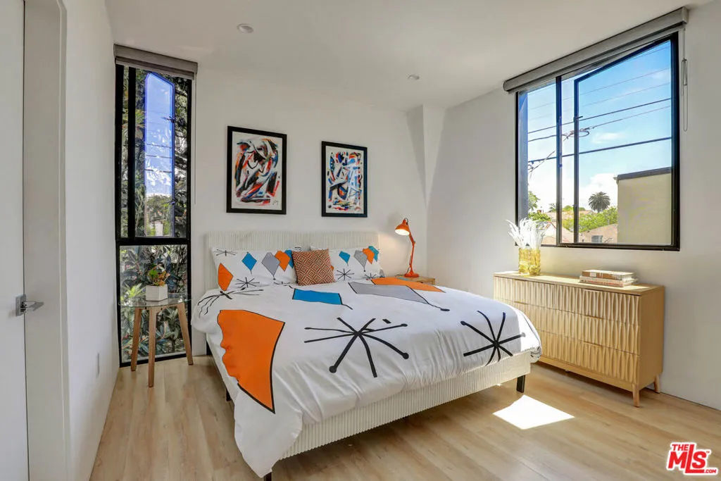 Bright primary bedroom with ta Bright primary bedroom with ta