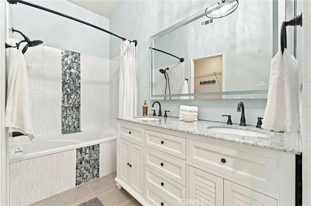 Beautifully remodeled dual-vanity sinks, and large soaking tub with shower, tile floors Beautifully remodeled dual-vanity sinks, and large soaking tub with shower, tile floors
