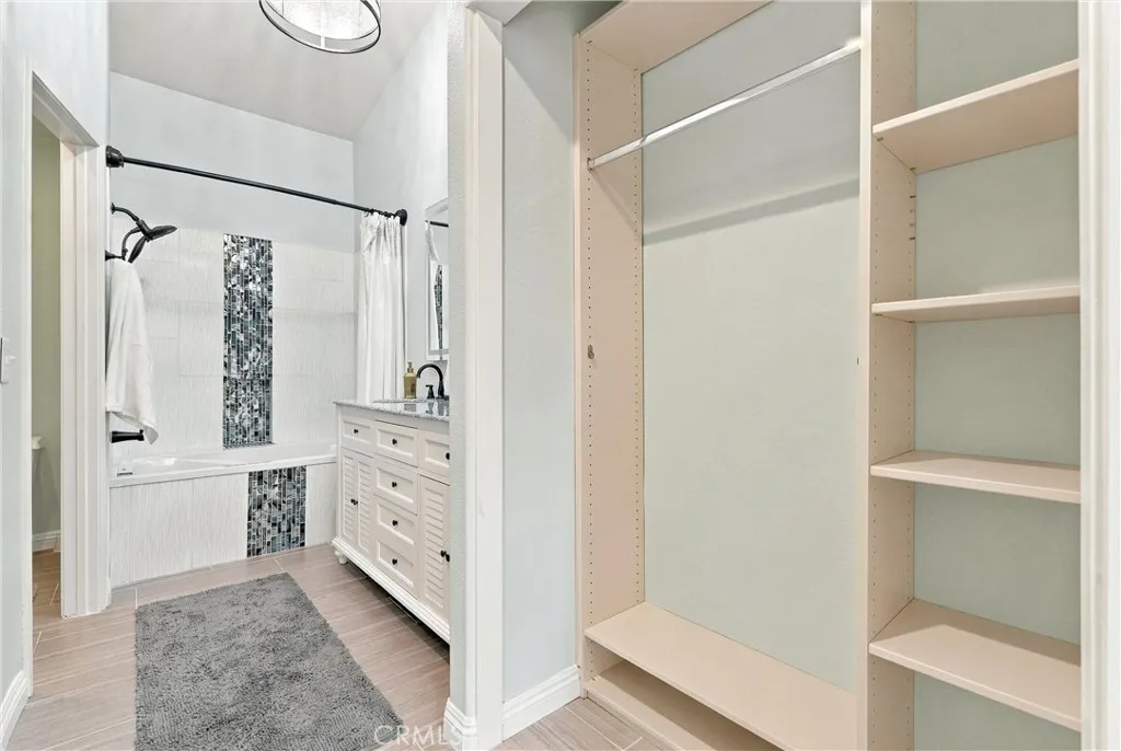Walk-through closet, leading to dual-vanity, large soaking tub with shower, bathroom Walk-through closet, leading to dual-vanity, large soaking tub with shower, bathroom