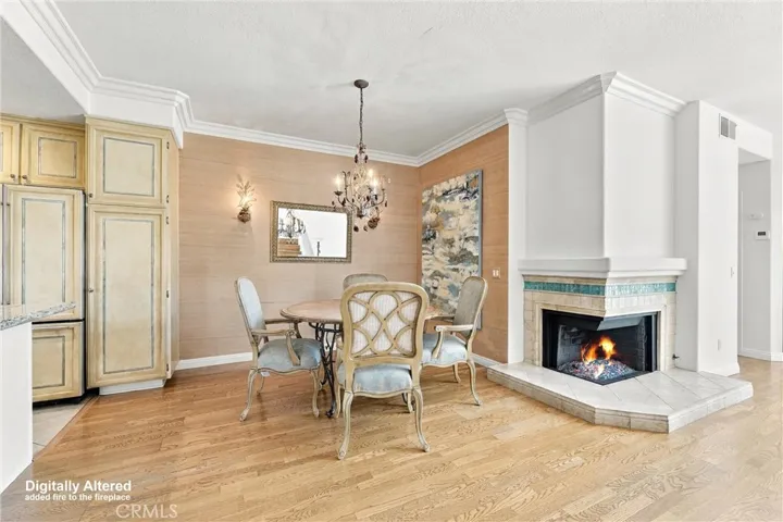 View of Dining area from front entrance, beautiful chandelier. (Fireplace flame digitally added).