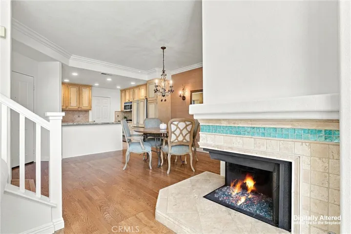 View of the Dining room area from Living room, Open Kitchen. (Fireplace Flame digitally added).