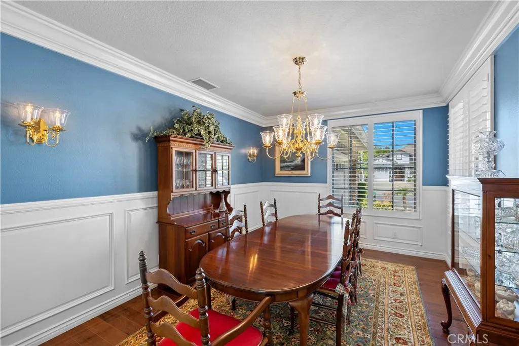 Stunning Formal Dining Room with Gorgeous Crown Molding, Intricate Wainscoting and Beautiful Plantation Shutters. Stunning Formal Dining Room with Gorgeous Crown Molding, Intricate Wainscoting and Beautiful Plantation Shutters.