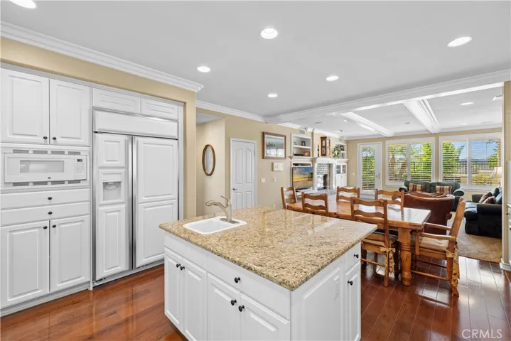 Immaculate Gourmet Kitchen with Center Island opens to a very Spacious Family Room.