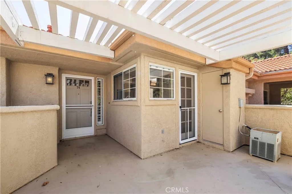 Front door and large, gated front patio. Front door and large, gated front patio.