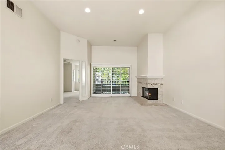 Living room with fireplace and slider to back deck.