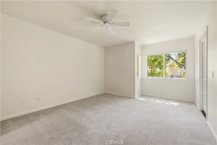 Spacious primary with door to back balcony.