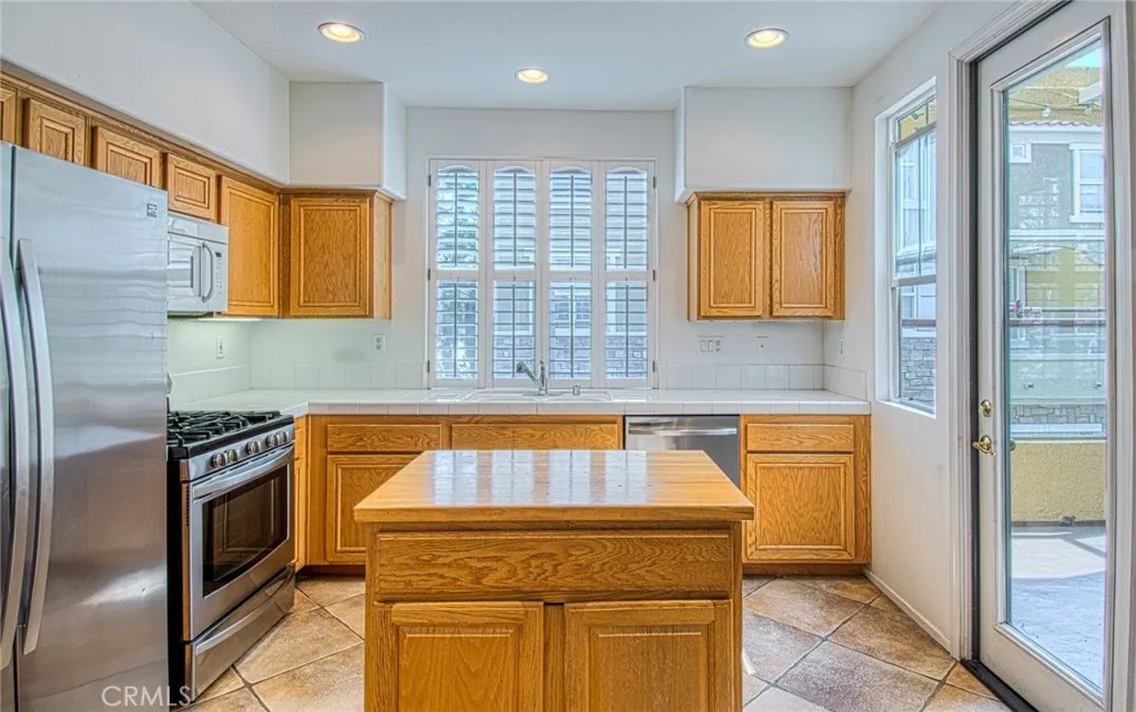 Kitchen with center island opens to balcony.