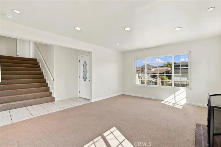 Spacious front living room that overlooks the front courtyard and park across the street.