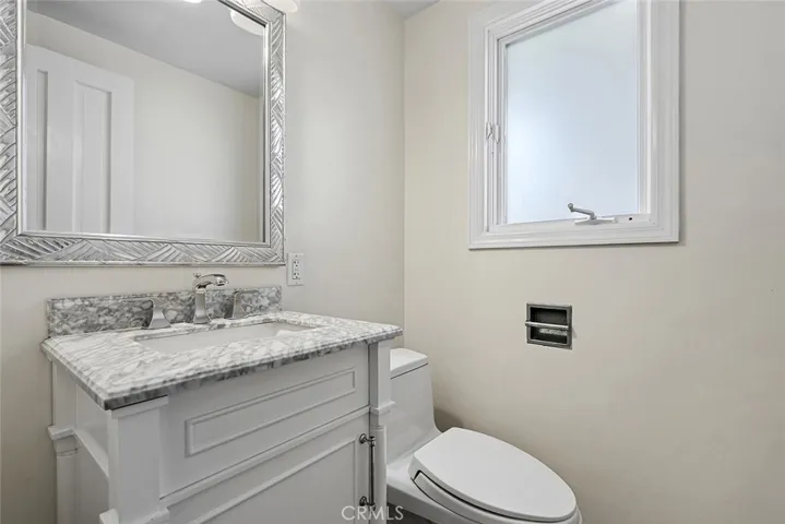 Powder room near laundry room and garage interior entrance