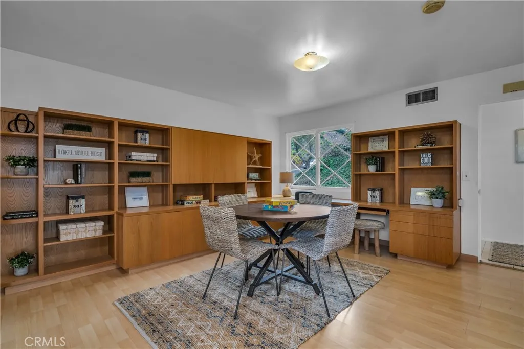 Family room with extensive built-in cabinets, desk and shelves Family room with extensive built-in cabinets, desk and shelves