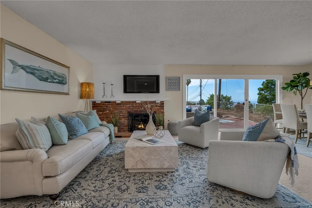 Living room with fireplace and direct access to rear patio and large grassy yard Living room with fireplace and direct access to rear patio and large grassy yard