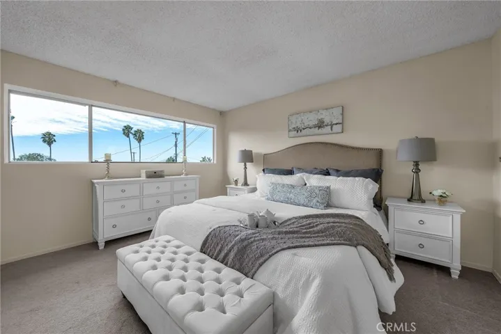 Master bedroom which looks out to large grassy backyard