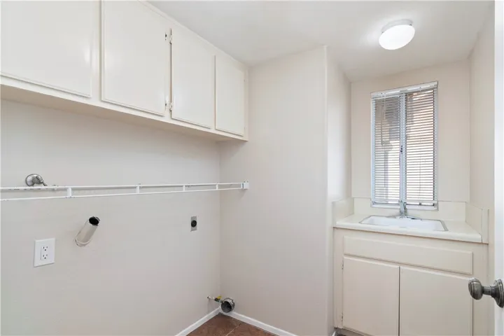 Interior laundry room with utility sink