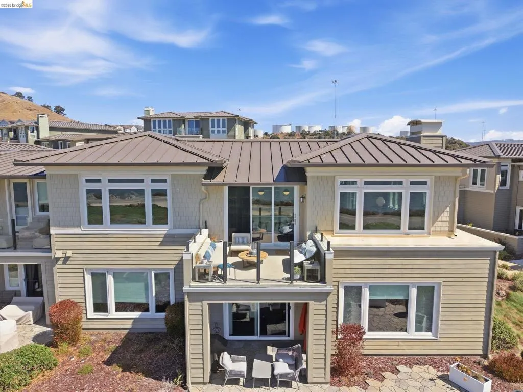 Multi-level exterior with horizontal siding and shingle accents