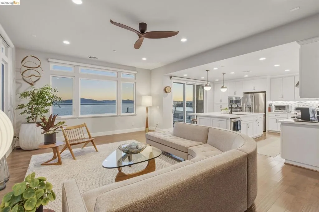 Open-concept living space featuring wood-finish flooring, recessed lighting, and a modern ceiling fan